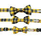 Set of three yellow and black plaid dog collars with matching bow ties on a white background.