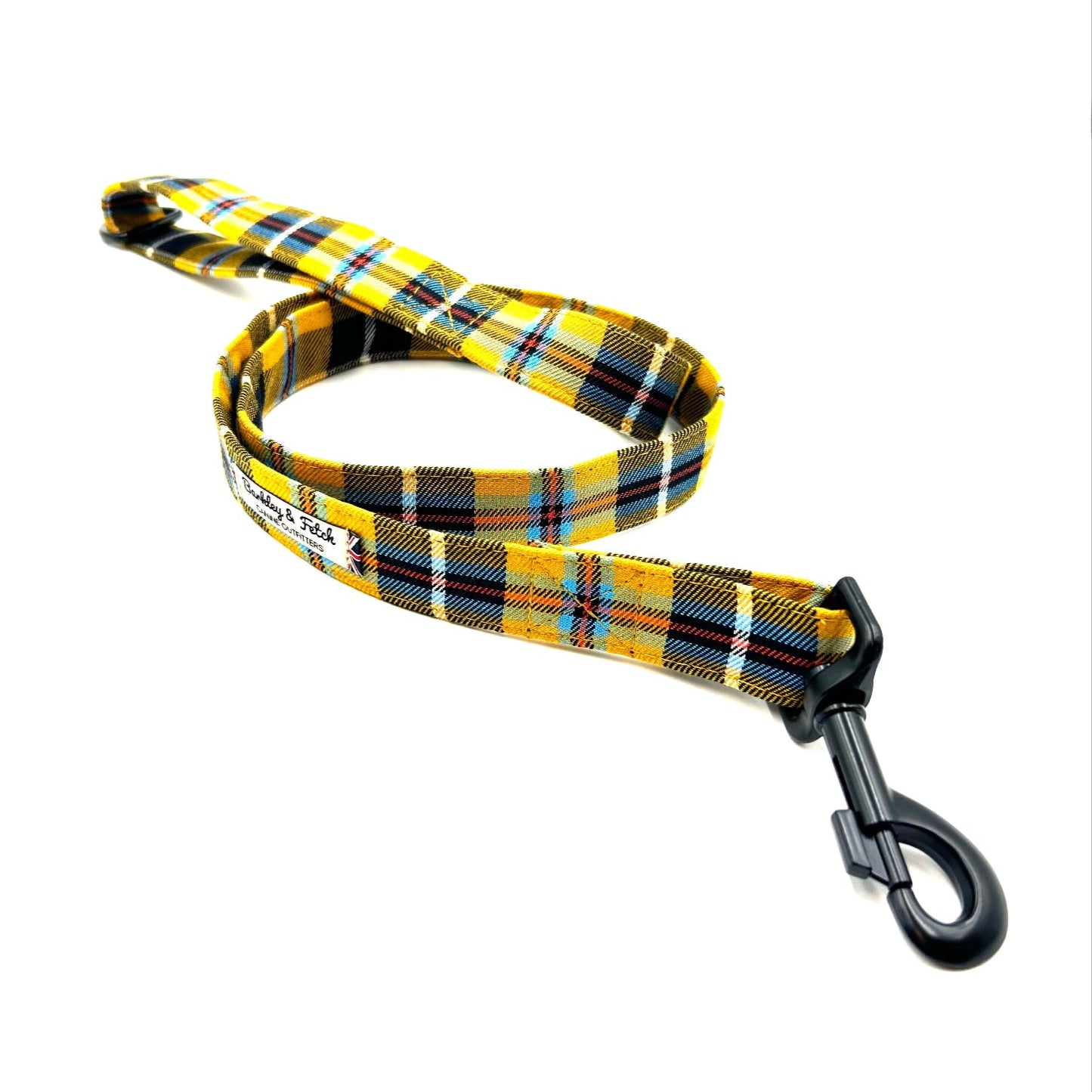 Yellow and black plaid dog leash on a white background