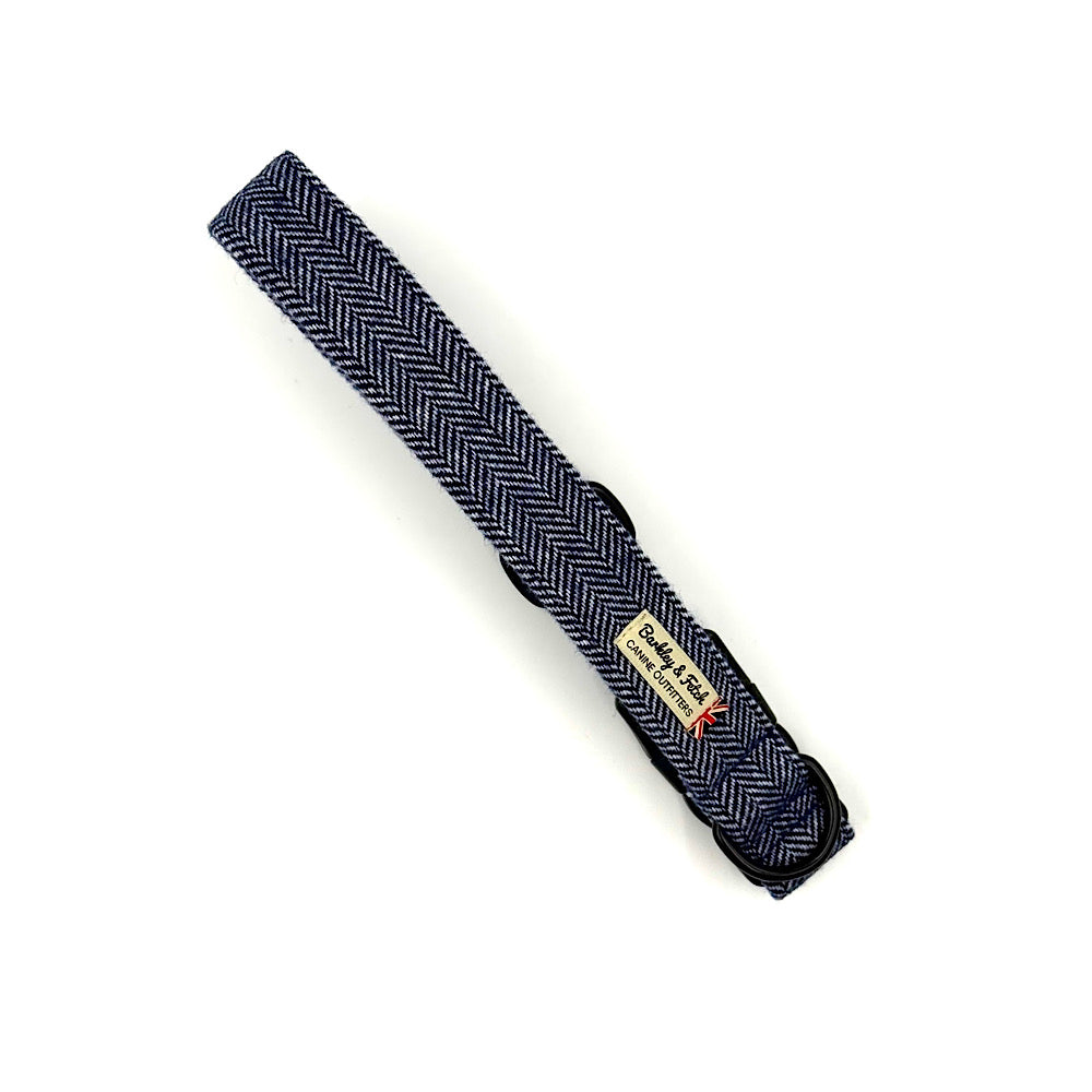 Navy herringbone tie with a label on a white background handmade in UK by Barkley And Fetch