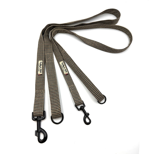 Dog leash with checkered pattern and metal clip on a white background