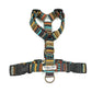 A striped multicolor dog harness with adjustable straps and side release buckles.