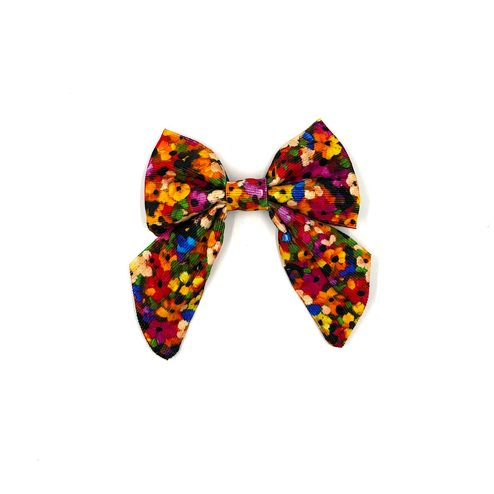 Multicolored bow on a white background handmade by Barkley And Fetch