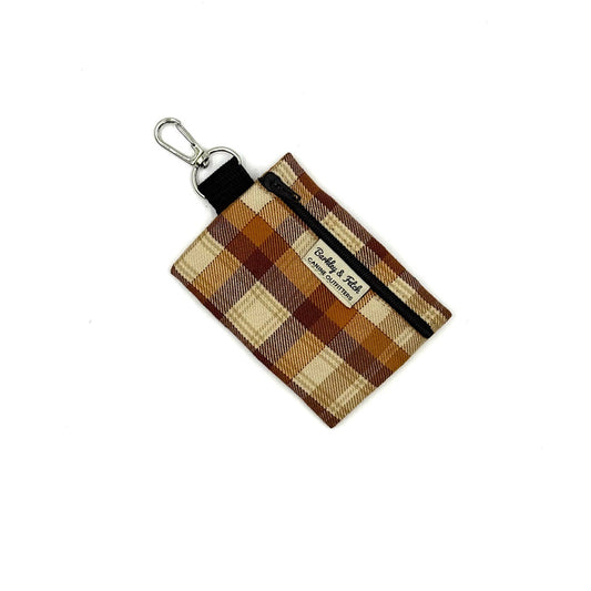 Plaid keychain pouch with a visible brand label on a white background