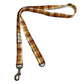 Plaid dog leash with metal clip on a white background