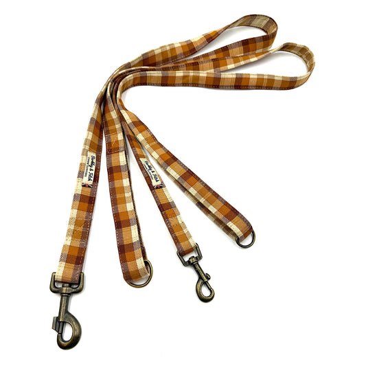 Plaid dog leash with metal clip on a white background