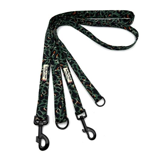Dog leash with green and black pattern on a white background