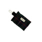 Black and green plaid pouch with a keyring on a white background