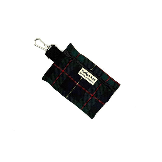 Black and green plaid pouch with a keyring on a white background