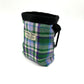 Plaid dog treat bag with black zipper on a white background