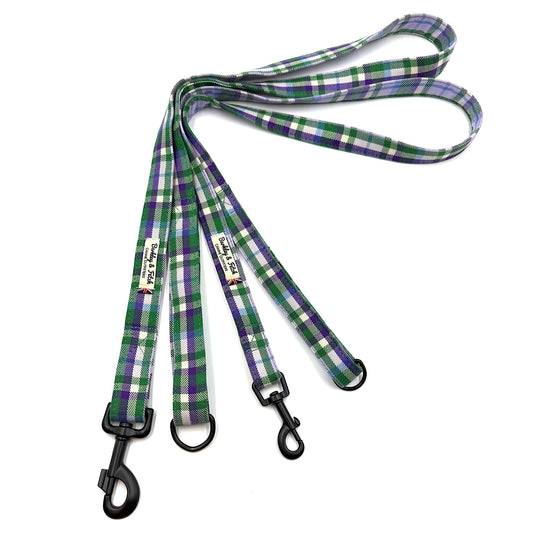Green and purple plaid dog leash with black clip on a white background