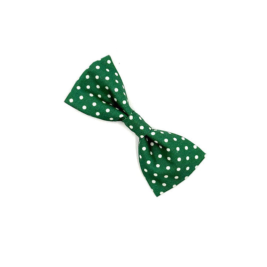 Green bow tie with white polka dots on a white background