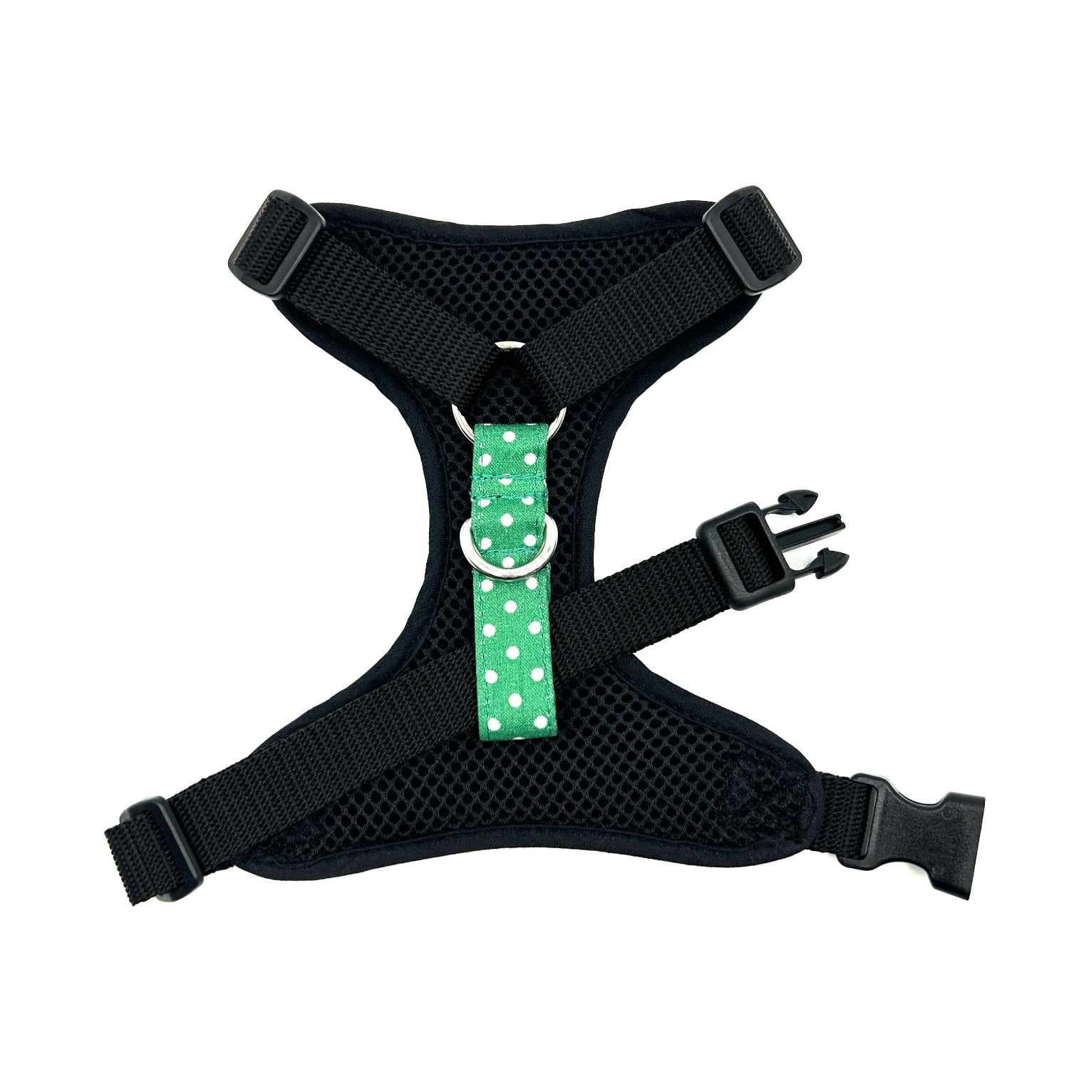 Black dog harness with a green polka dot strap on a white background