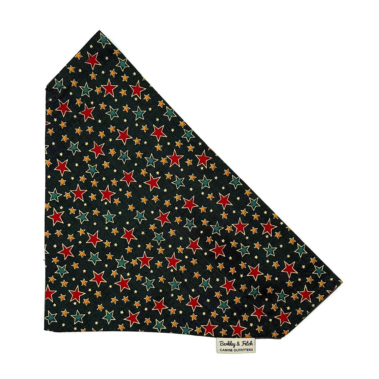 Star-patterned fabric with red, green, and gold stars on a black background handmade by barkley and fetch uk