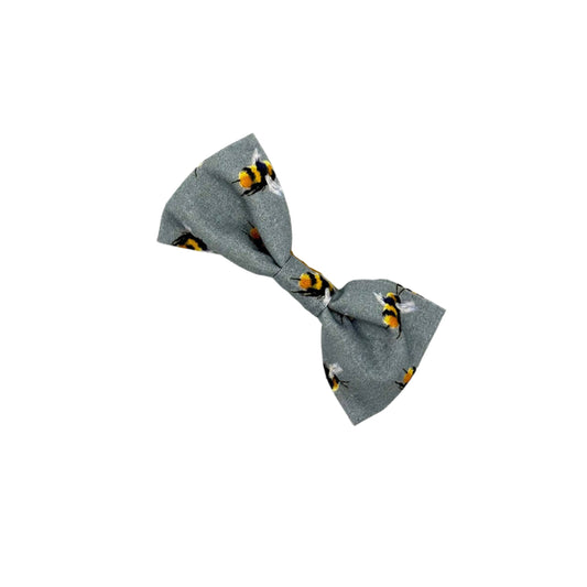 Gray bow tie with black and yellow pattern on a white background
