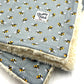 Blanket with bee pattern and visible brand logo on a light background handmade by barkley and fetch uk