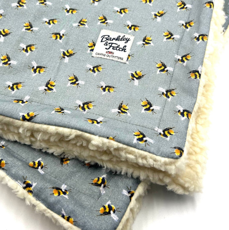 Blanket with bee pattern and visible brand logo on a light background handmade by barkley and fetch uk