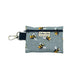 A small grey zip pouch with a bee print design, featuring a black strap with the text 'barkley and fetch' and a metal keychain loop.