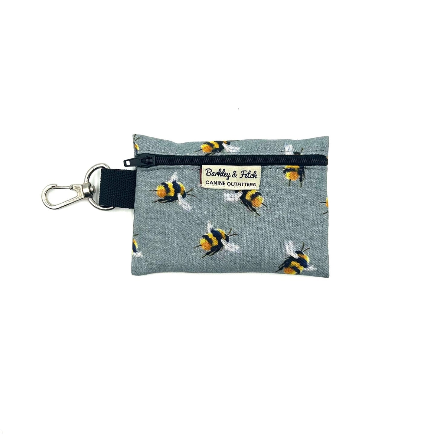A small grey zip pouch with a bee print design, featuring a black strap with the text 'barkley and fetch' and a metal keychain loop.