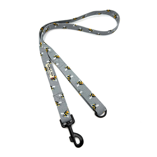 Gray dog leash with black clip and small dog pattern on a white background. Handmade in the uk by Barkley and Fetch