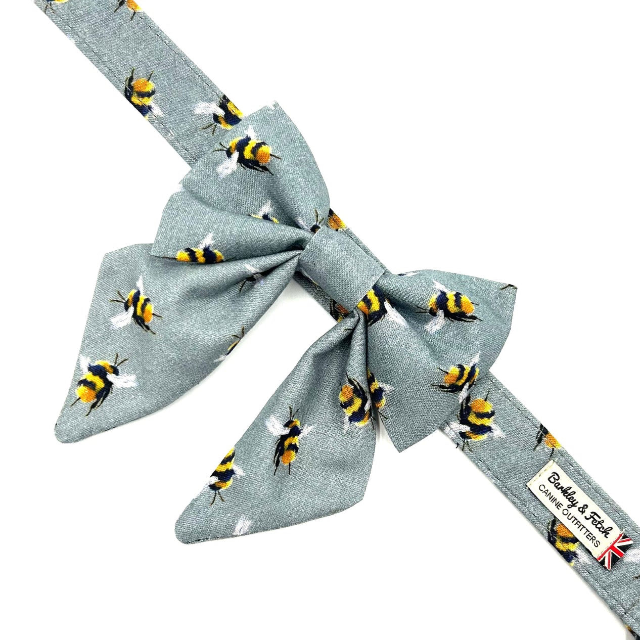 Bow tie with bee pattern on a light blue background handmade in uk by barkley and fetch