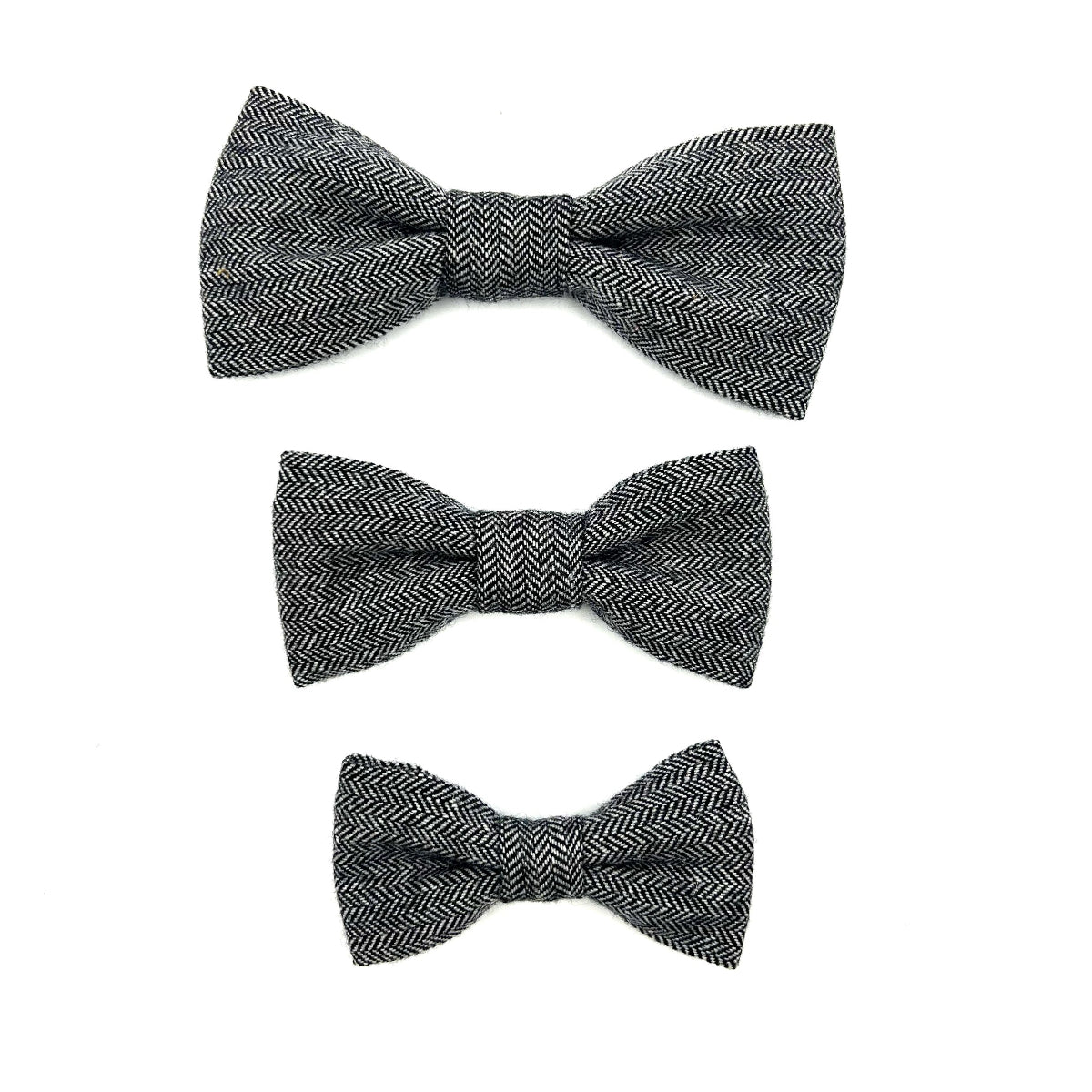 Three black herringbone patterned bow ties on a white background