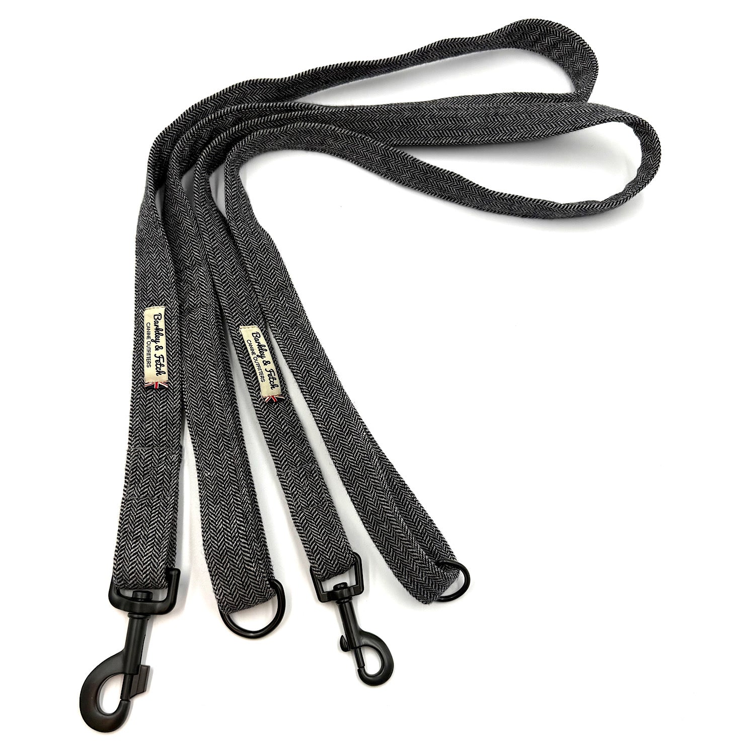 Black dog leash with metal clasp on a white background
