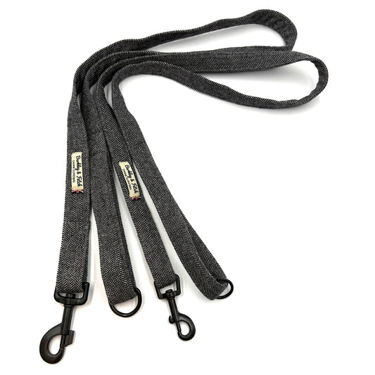 Black dog leash with metal clasp on a white background
