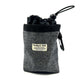 Grey textured pouch with black drawstring and carabiner, featuring a label on a white background. Handmade in the UK by Barkley and Fetch