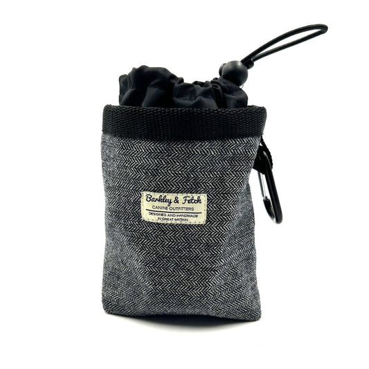 Grey textured pouch with black drawstring and carabiner, featuring a label on a white background. Handmade in the UK by Barkley and Fetch