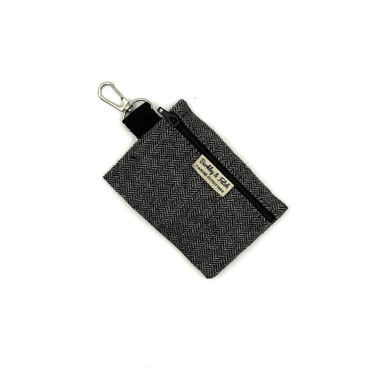 Black herringbone fabric pouch with keychain clip on a white background