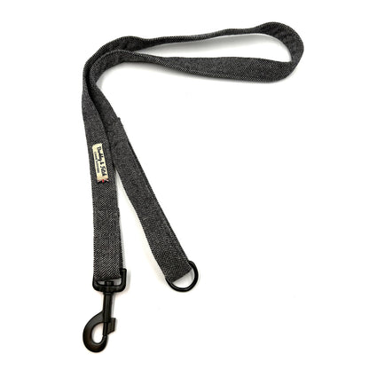 Black dog leash with a clip on a white background
