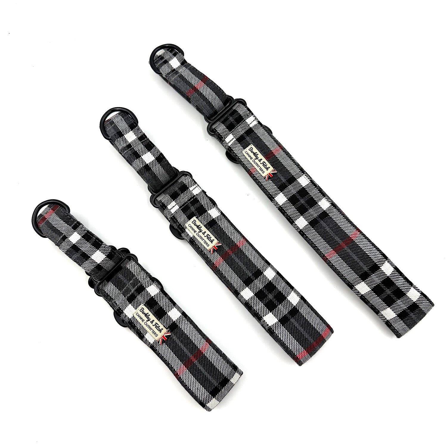Three black and white plaid dog collars with red accents on a white background