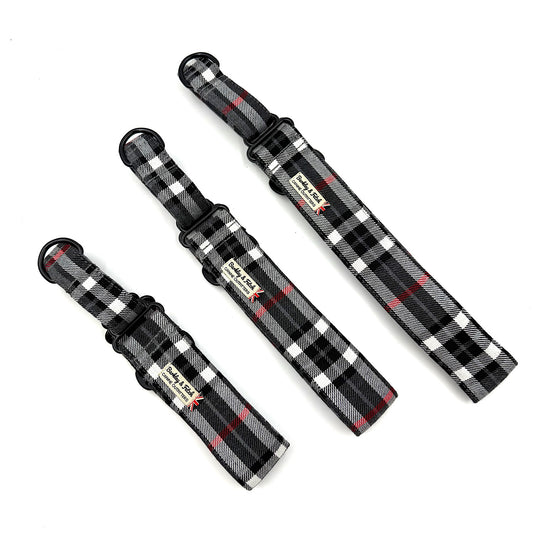 Three black and white plaid dog collars with red accents on a white background
