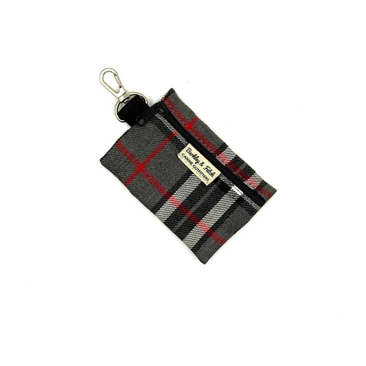 Plaid keychain pouch with a visible brand label on a white background
