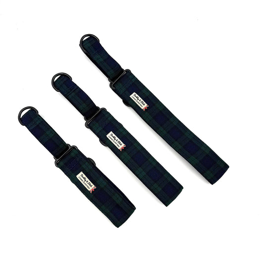 Three black plaid dog collars with visible brand labels on a white background
