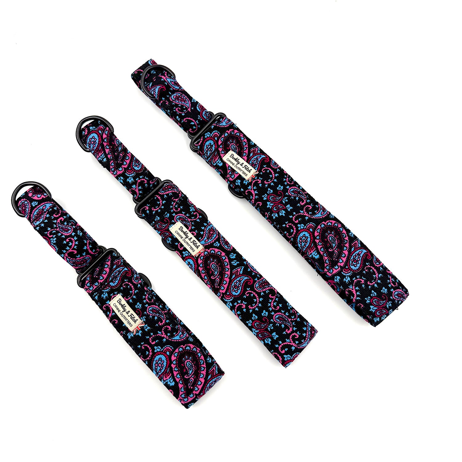 Three black dog collars with pink and blue paisley patterns on a white background