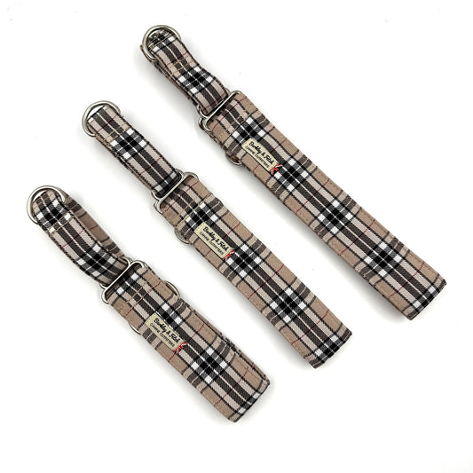 Three plaid dog collars on a white background