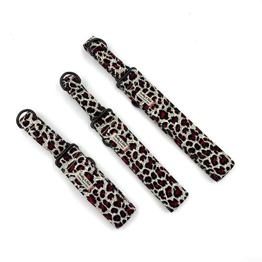 Three leopard print dog collars on a white background