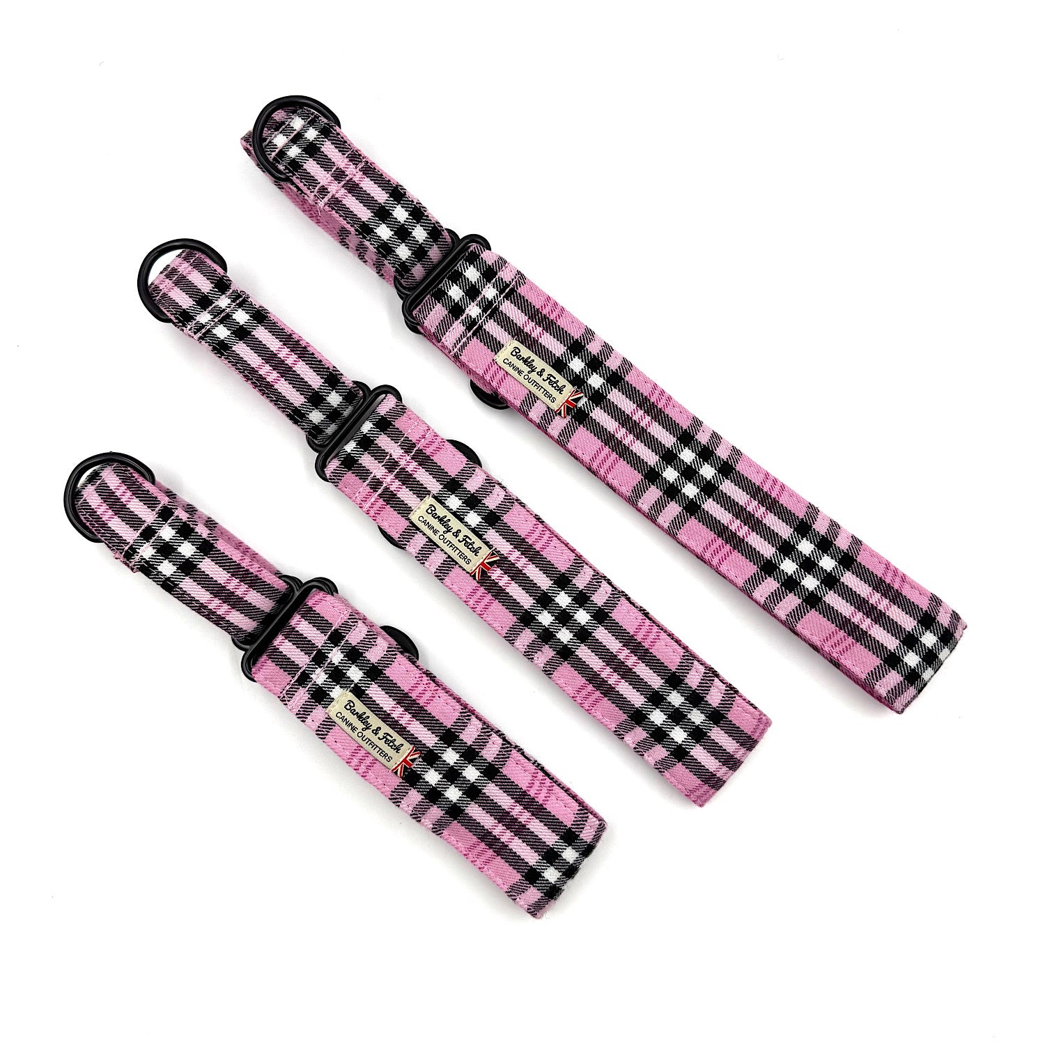 three pink and black checkered dog collars on a white background