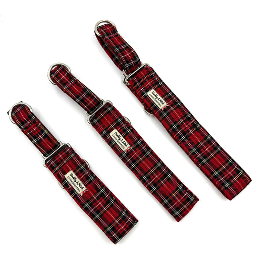 Three red plaid dog collars with metal buckles on a white background