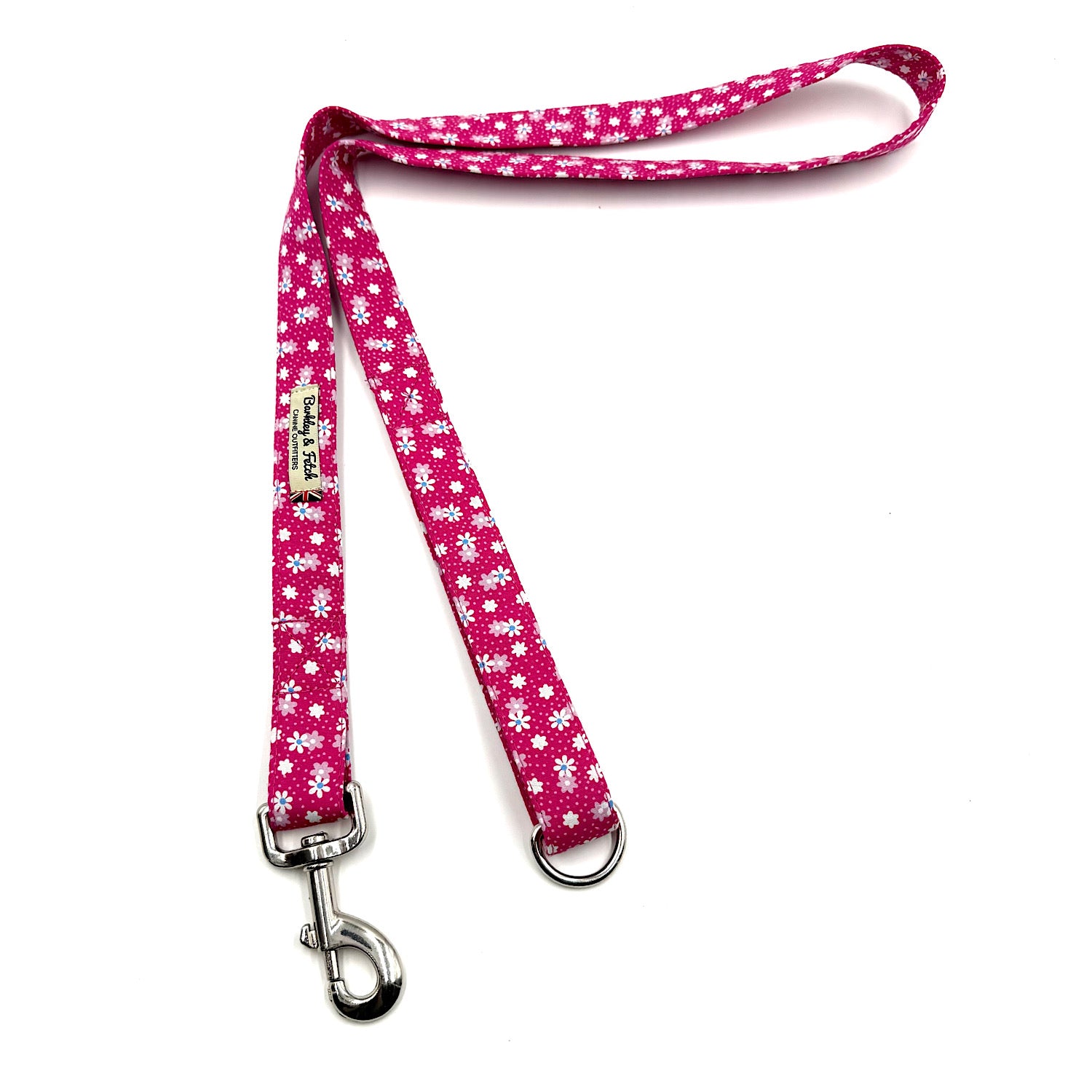 Pink dog leash with white floral pattern on a white background