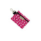 Pink keychain pouch with white floral pattern on a white background