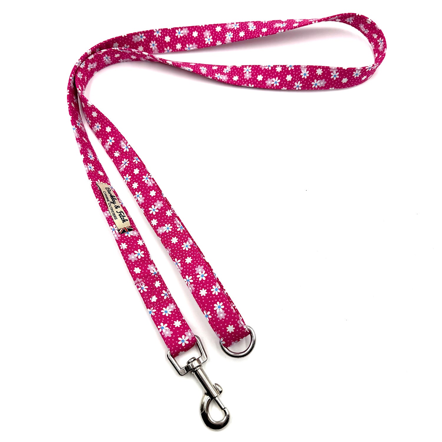Pink dog leash with white floral pattern on a white background