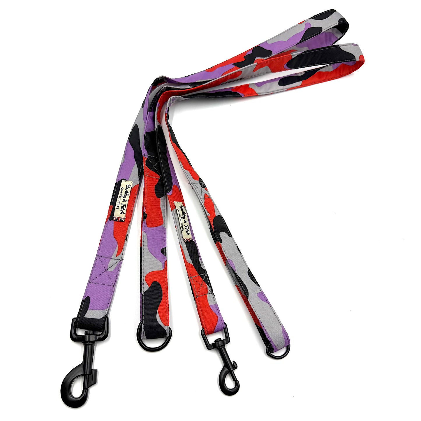Colorful camouflage-patterned dog leash with black clip on a white background