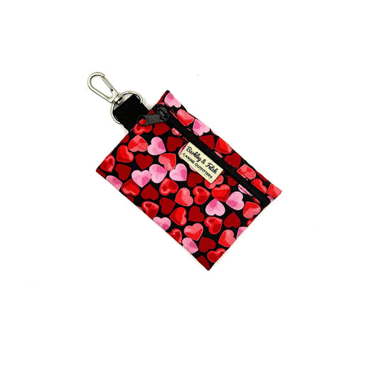 Small pouch with heart pattern and keychain clip on a white background