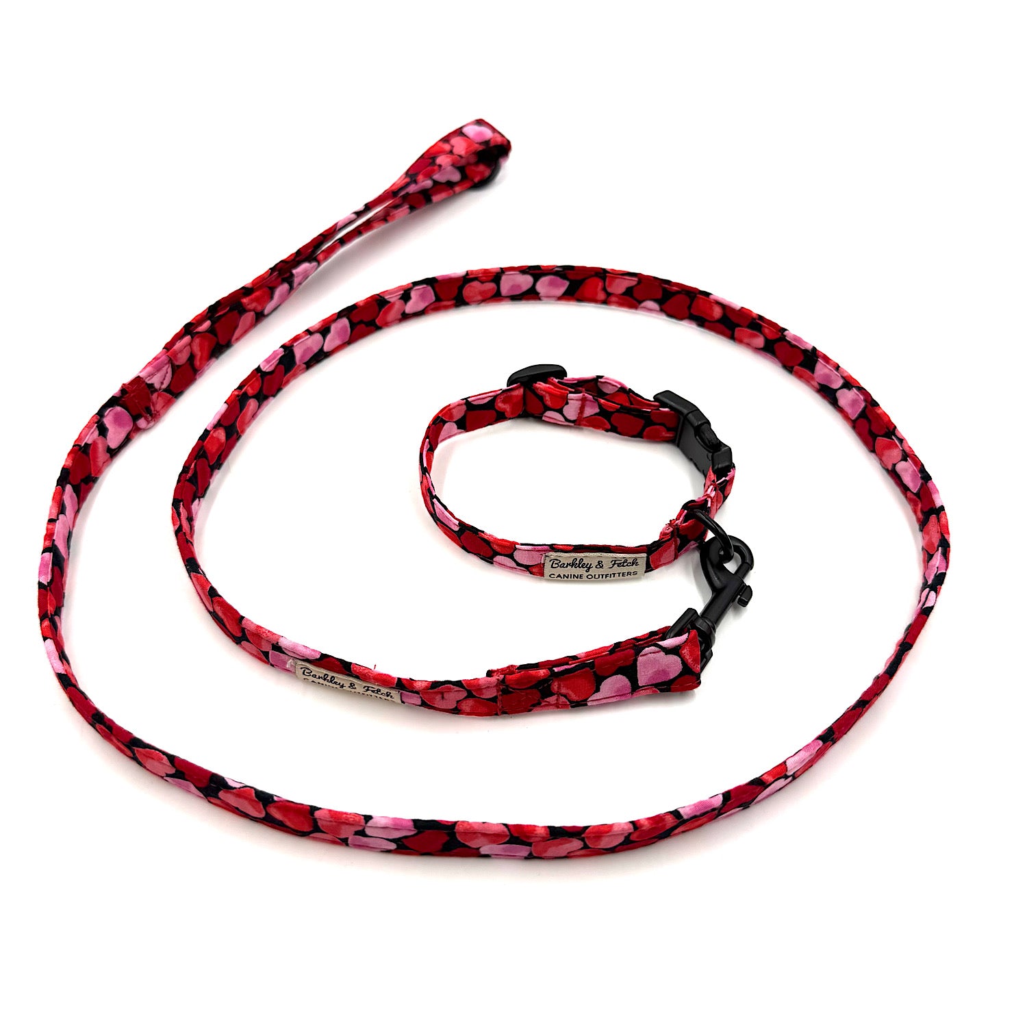 Dog leash and collar set with pink heart pattern on a white background