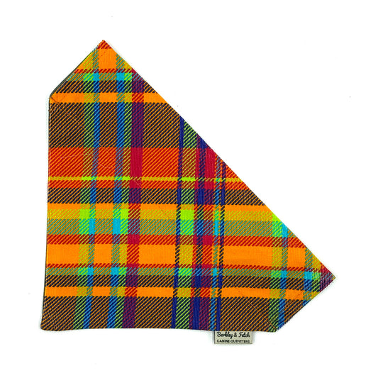 Colorful plaid fabric with a brand label on a white background HANDMADE IN UK BY BARKLEY AND FETCH