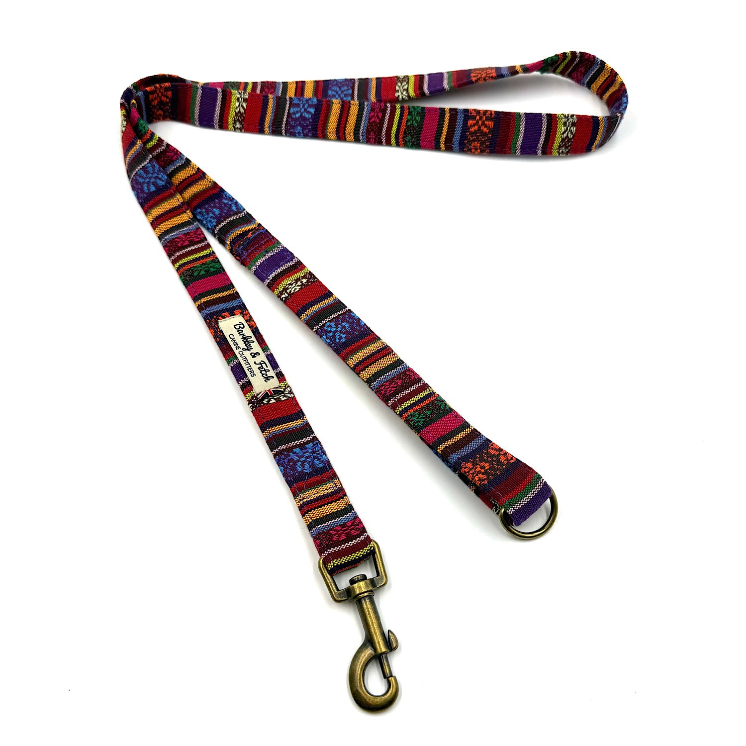Colorful patterned dog leash with a gold clasp on a white background