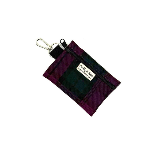 Purple key fob pouch with a visible brand label on a white background