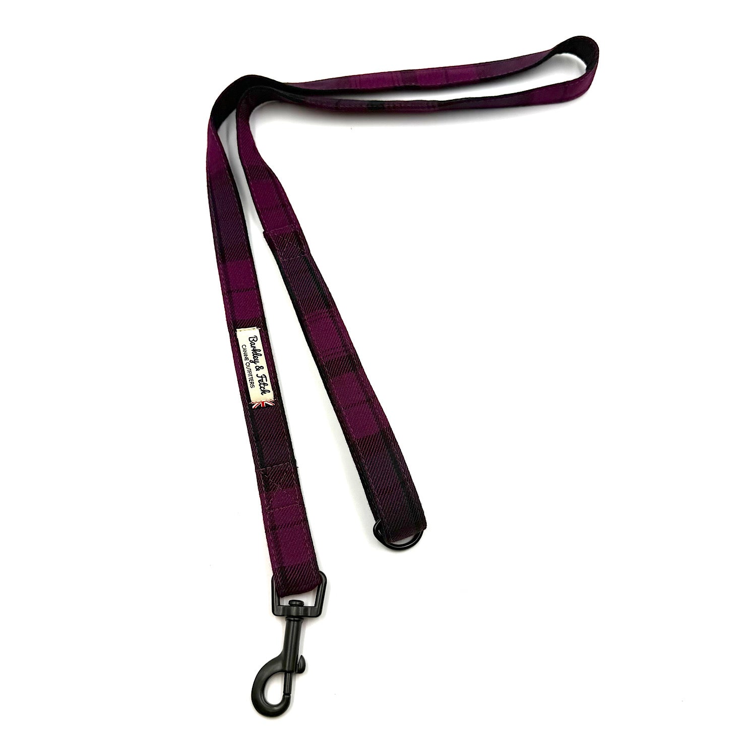 Plaid dog leash with a metal clip on a white background